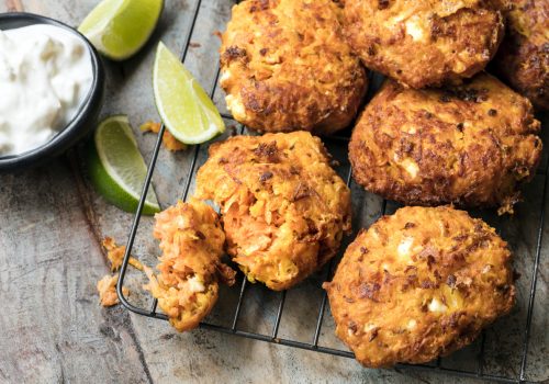 Fritters with carrots, sweet potato and feta cheese, served with yogurt and lime.